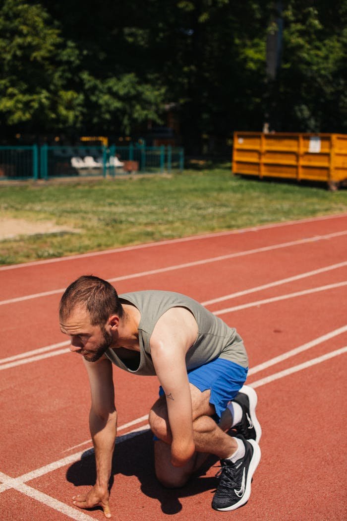 Amputee athlete on a track, showing determination and strength before a race.